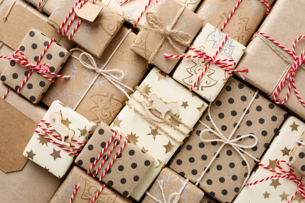 Christmas background with gift boxes wrapped in brown kraft paper flat lay.