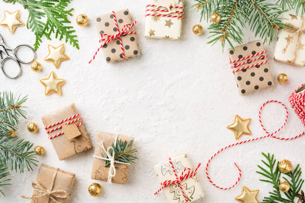 istock Wrapped Christmas gift boxes, decorations, twine & spruce on white background. 1083761072