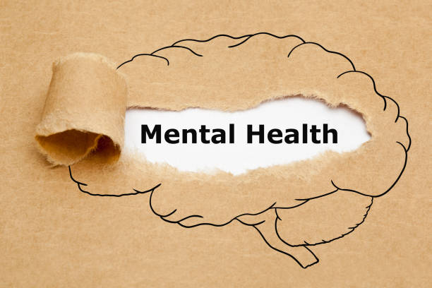 Text Mental Health appearing behind torn brown paper with drawn human brain on it.