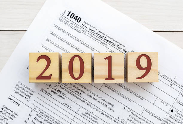istock Wooden cubes with numbers 2019 on tax form. 1083770092
