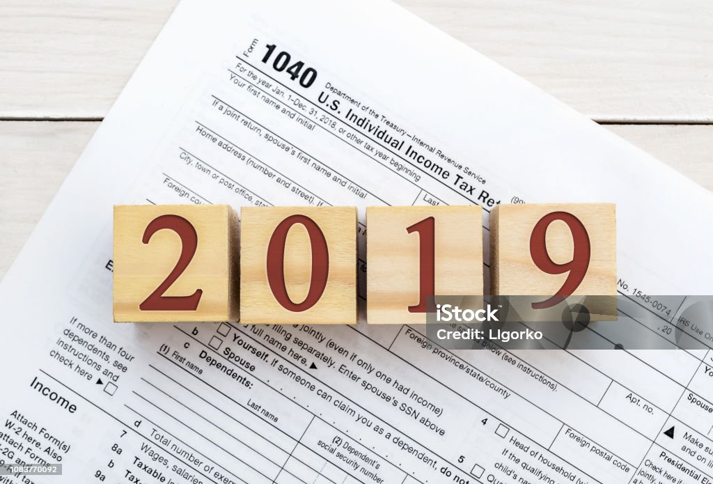 Wooden cubes with numbers 2019 on tax form. 2019 Stock Photo