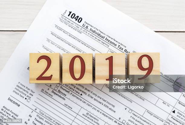 Wooden Cubes With Numbers 2019 On Tax Form Stock Photo - Download Image Now - 2019, Accountancy, April