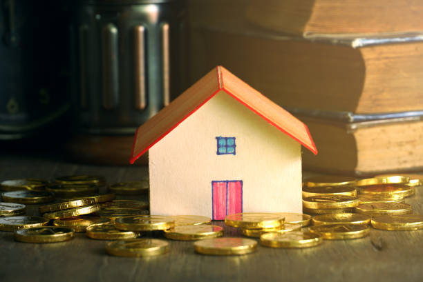 istock House model and gold coin stack on the table, finance concept 1083770170