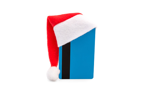 Santa's hat on credit card on white.