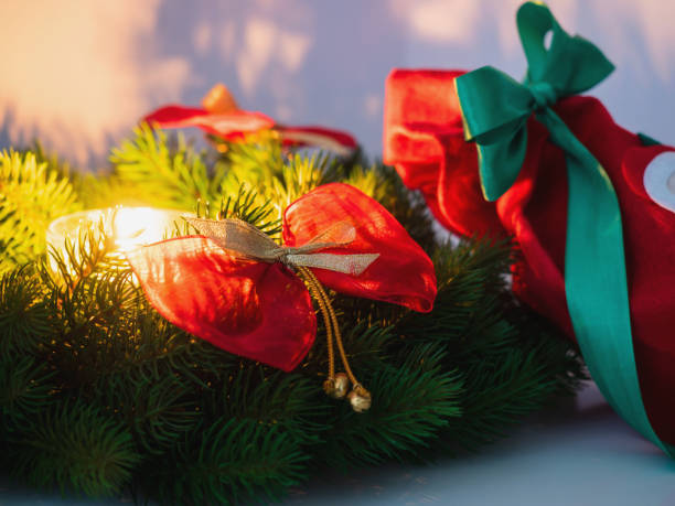 istock Christmas wreath and candle. Dark background with  place for text. Selective focus. 1083772306