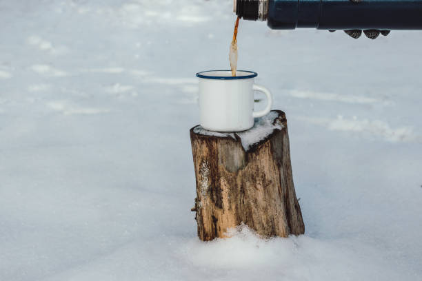 istock Closeup of white enamel cup with hot  beverage enamel on a stub, selective focus 1083772782