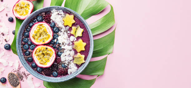 istock Smoothie acai bowl served in bowl on pink table 1083772924