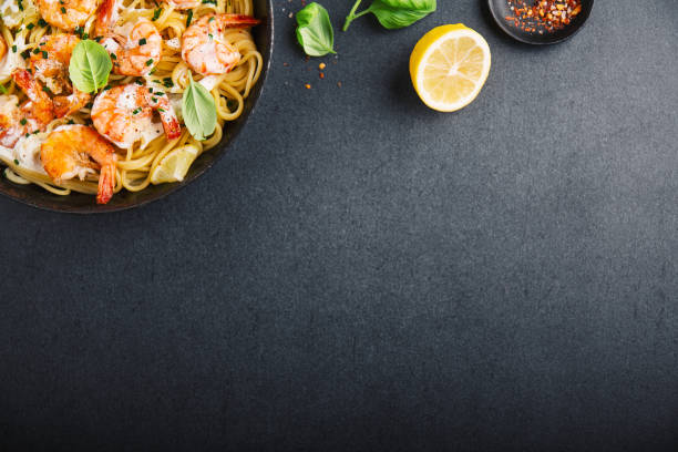 istock Fried fresh shrimps with spices on black pan 1083773340