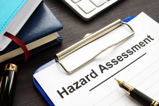 Hazard assessment form with clipboard on a desk.