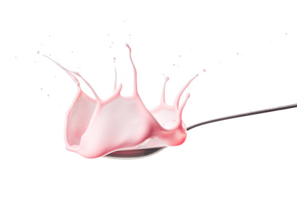 istock Strawberry splashing into a spoon full of yogurt. 1083776608