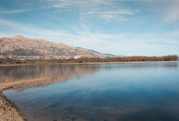 istock Mountains and trees reflected in the water of a lake 1083779850
