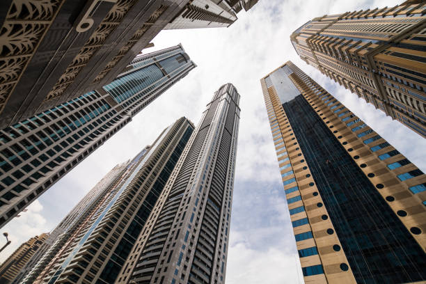 DUBAI, UAE - OCTOBER 2018: Dramatic perspective with low angle view of skyscrapers looking up to the sky, Dubai. Vanishing point