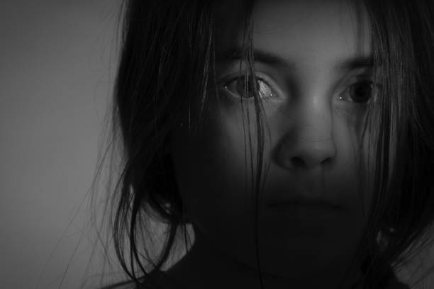 istock Portrait with shadow of a sad girl 1083788526