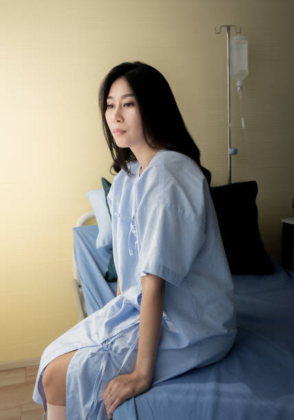 istock Female patient sitting on bed 1083791670