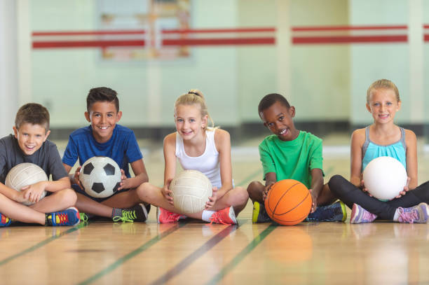 istock Kids with balls in a gym 1083803560