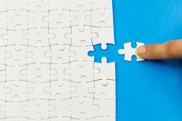 istock business people assembling jigsaw puzzle and represent team support and help concept. 1083804214