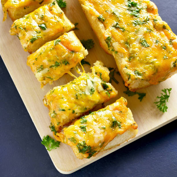 istock Cheese and garlic bread with greens 1083809300