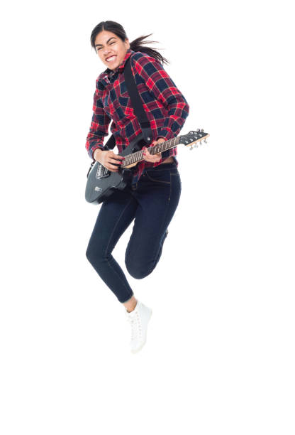istock Beautiful young latino female playing an electrical guitar 1083809776