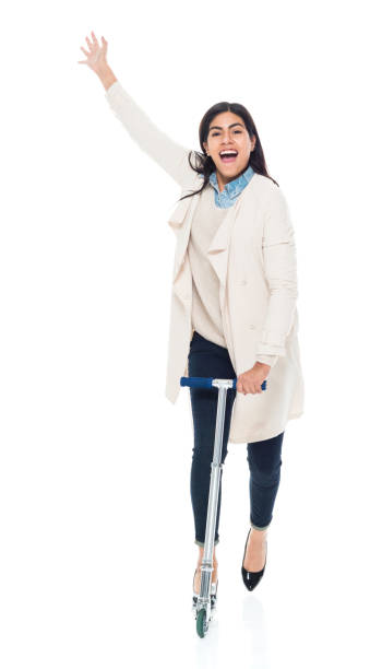 istock Attractive young latino female is riding a schooter 1083811426