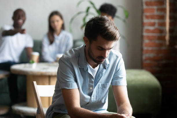 istock Upset young man suffering from gossiping, bullying 1083813354