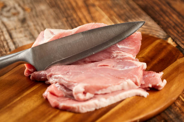 istock Pork leg and chef's knife 1083816346