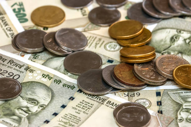 istock Indian rupees coins. 500 rupee banknotes in background. 1083816936