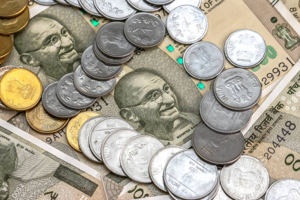 istock Indian rupees coins. 500 rupee banknotes in background. 1083816984