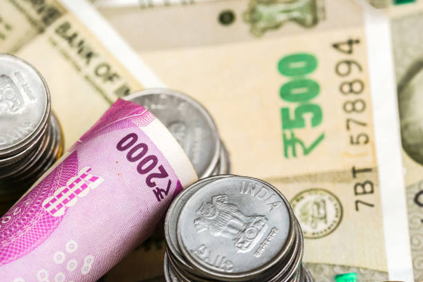 istock New indian 2000 rupees banknote and coins. 500 rupee banknotes in background. 1083818168
