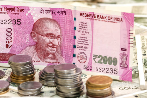 istock New indian 2000 rupees banknote and coins. 500 rupee banknotes in background. 1083818372