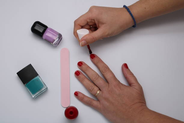 istock Manicurist painting nails 1083818542
