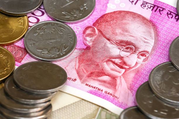 istock New indian 2000 rupees banknote and coins. 500 rupee banknotes in background. 1083818642