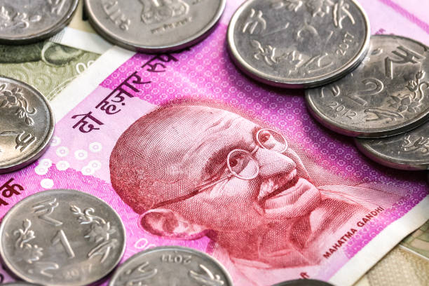 istock New indian 2000 rupees banknote and coins. 500 rupee banknotes in background. 1083818934