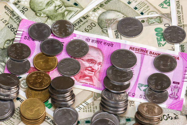 istock New indian 2000 rupees banknote and coins. 500 rupee banknotes in background. 1083819310