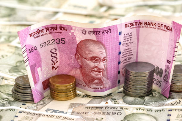 istock New indian 2000 rupees banknote and coins. 500 rupee banknotes in background. 1083819608