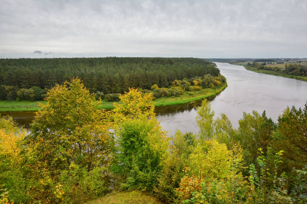 istock Autumn landscape on cool, cloudy day. Panoramic view of the forest and Neman river. 1083822448
