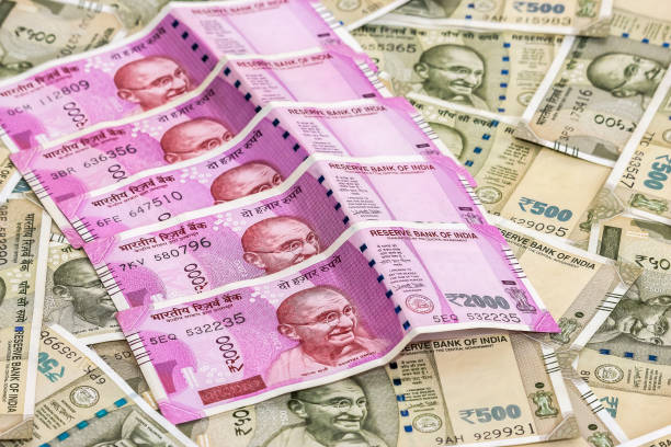 istock New indian 2000 rupees banknotes. 500 rupee banknotes in background. 1083822498