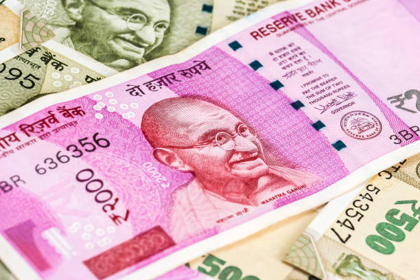istock New indian 2000 rupees banknotes. 500 rupee banknotes in background. 1083823130