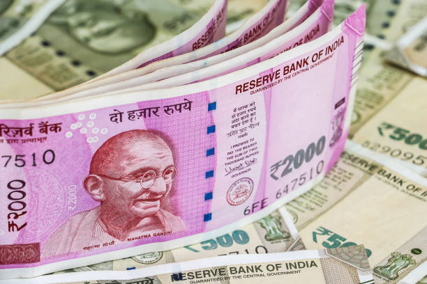 istock New indian 2000 rupees banknotes. 500 rupee banknotes in background. 1083823400
