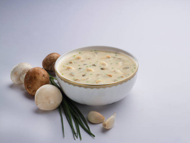 istock Cream soup with mushrooms on white background. 1083826304