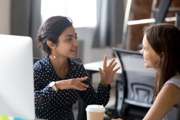 istock Friendly female colleagues having pleasant conversation 1083827536