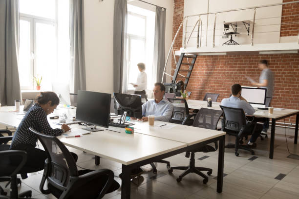 istock Serious team of employees working in modern office 1083827674