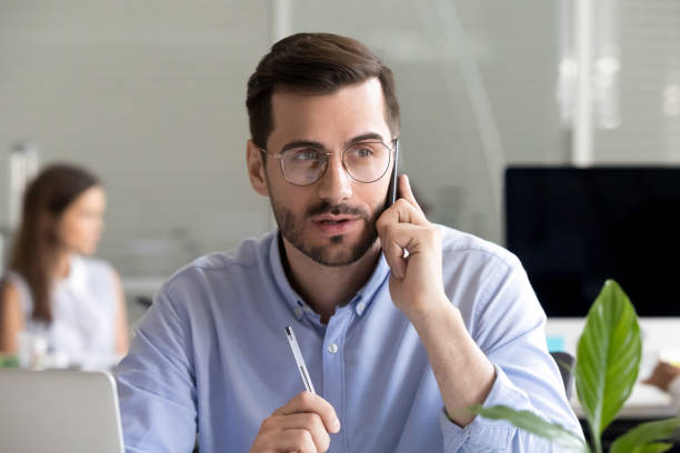 istock Focused businessman consulting client by phone at workplace 1083827740
