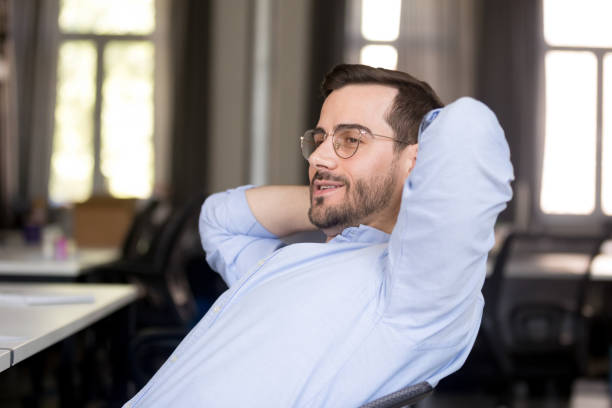 istock Confident businessman relaxing leaning back at workplace 1083827742