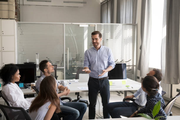 istock Confident leader, coach holding briefing for multiracial team employees 1083827806