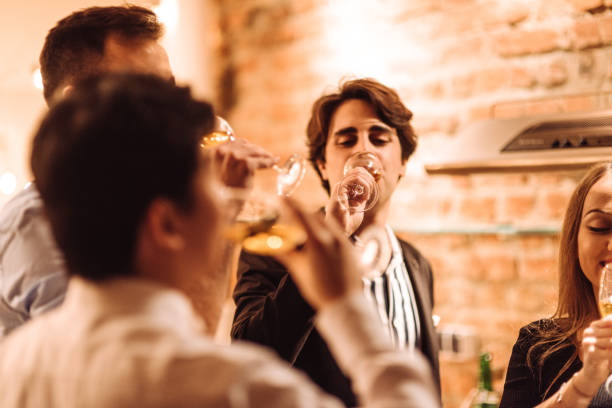 istock friends drinking wine at home 1083829698