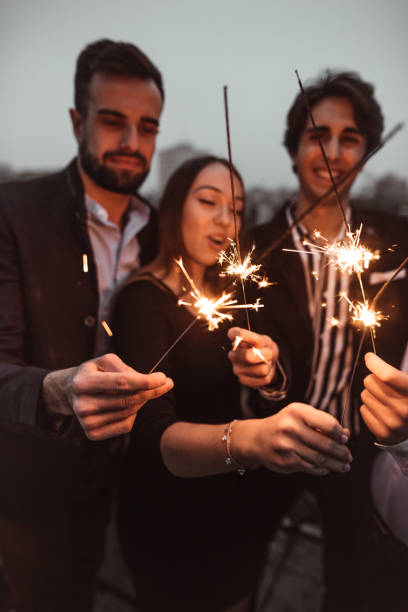istock friends celebrate the new year on the rooftop 1083830004