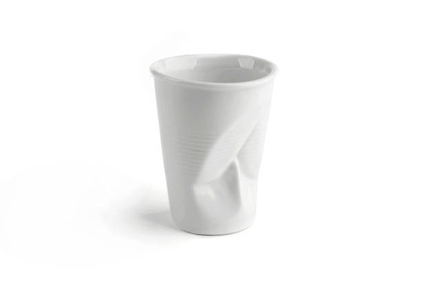istock Design crumpled ceramic coffee cup as plastic one time cup isolated on white background. 1083830164