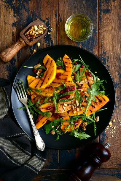 istock Grilled pumpking warm salad with arugula, walnuts and pomegranate seeds 1083844420