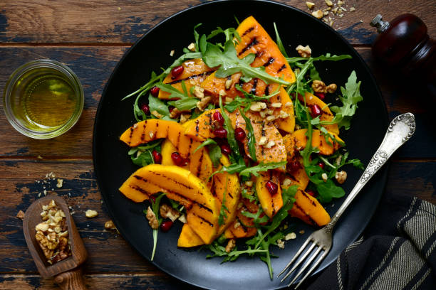 Grilled pumpking warm salad with arugula, walnuts and pomegranate seeds