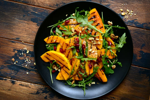 istock Grilled pumpking warm salad with arugula, walnuts and pomegranate seeds 1083844644